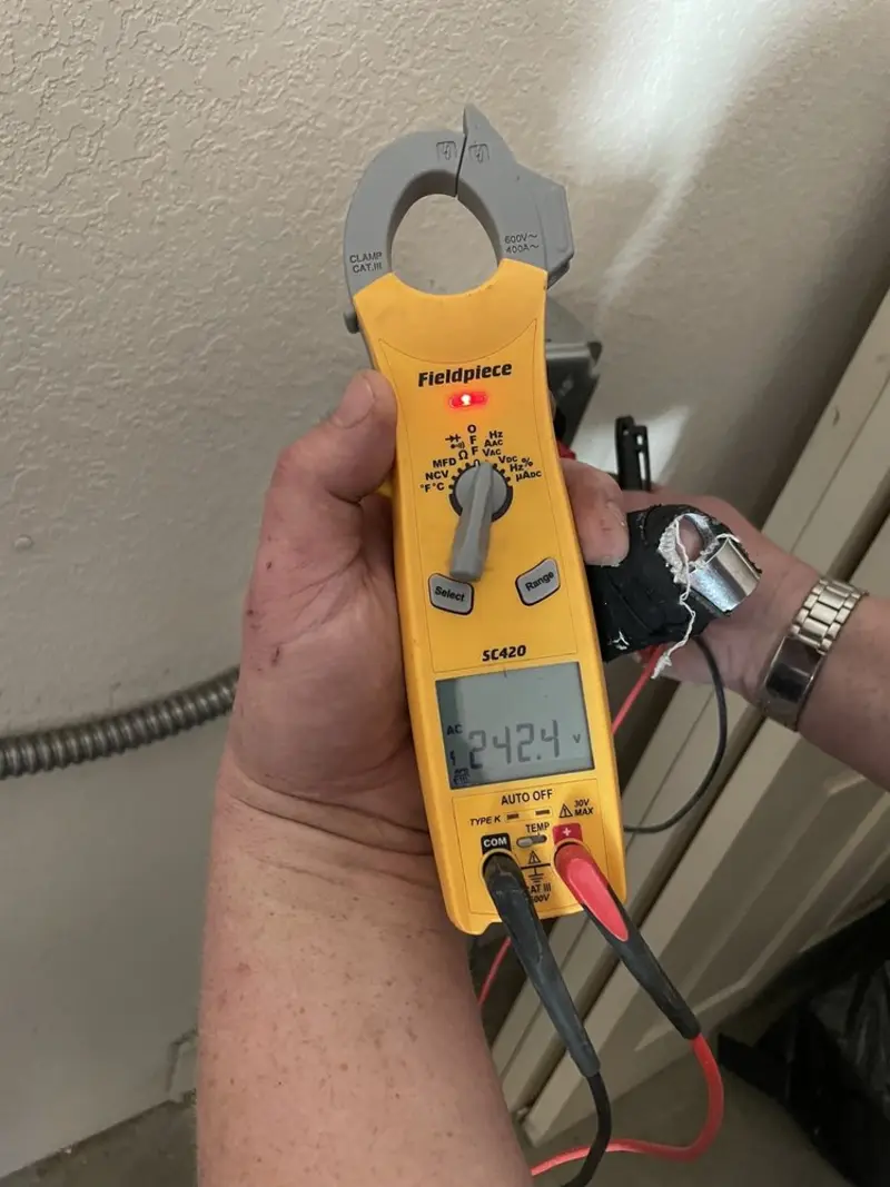Voltage testing with clamp meter during Ceiling Fan Installation in Evergreen